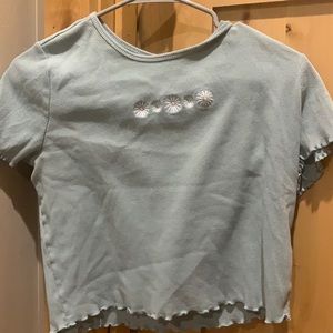 Green Hollister tee with daisies and lettuce trim sleeves